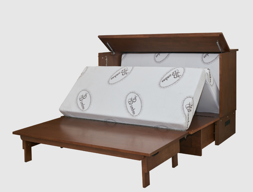 A wooden storage bed frame with its lift-up lid open, showing a white mattress or mattress topper with printed logos, set against a plain light gray background.